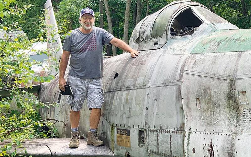 man by old plane