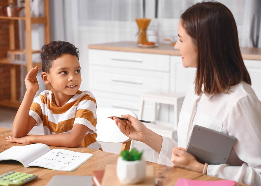 child getting tutored by adult