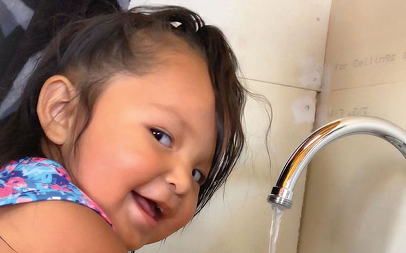 child washing hands