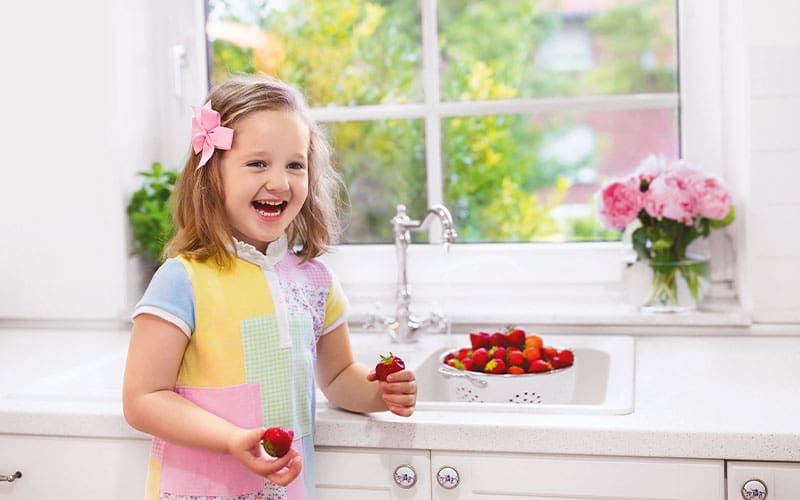little girl with strawberries
