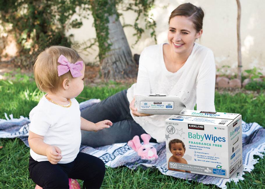woman with toddler sitting on the grass