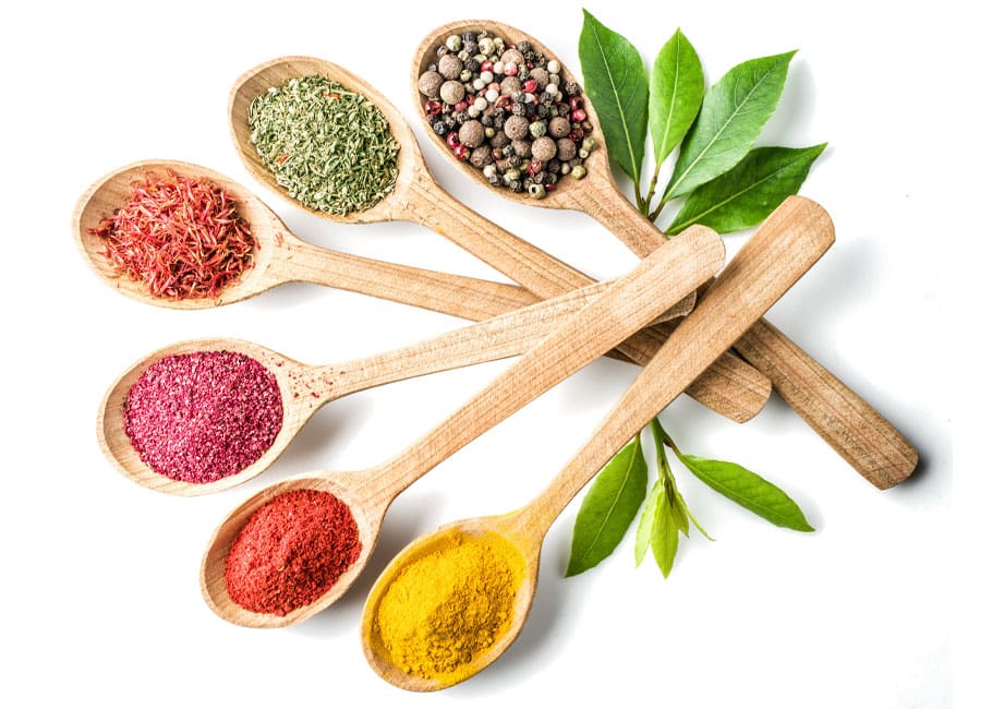 wooden spoons filled with spices