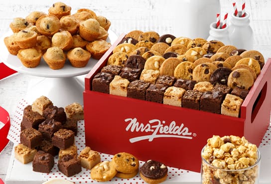 A box of Mrs. Fields treats, including mini muffins, brownies and cookies.